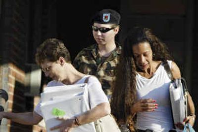 
Pfc. Lynndie England, middle, is flanked by her mother Terrie England, left, and Kathleen Johnson, right, as she leaves the Staff Judge Advocate Building at Fort Bragg, N.C., on Friday. 
 (Associated Press / The Spokesman-Review)