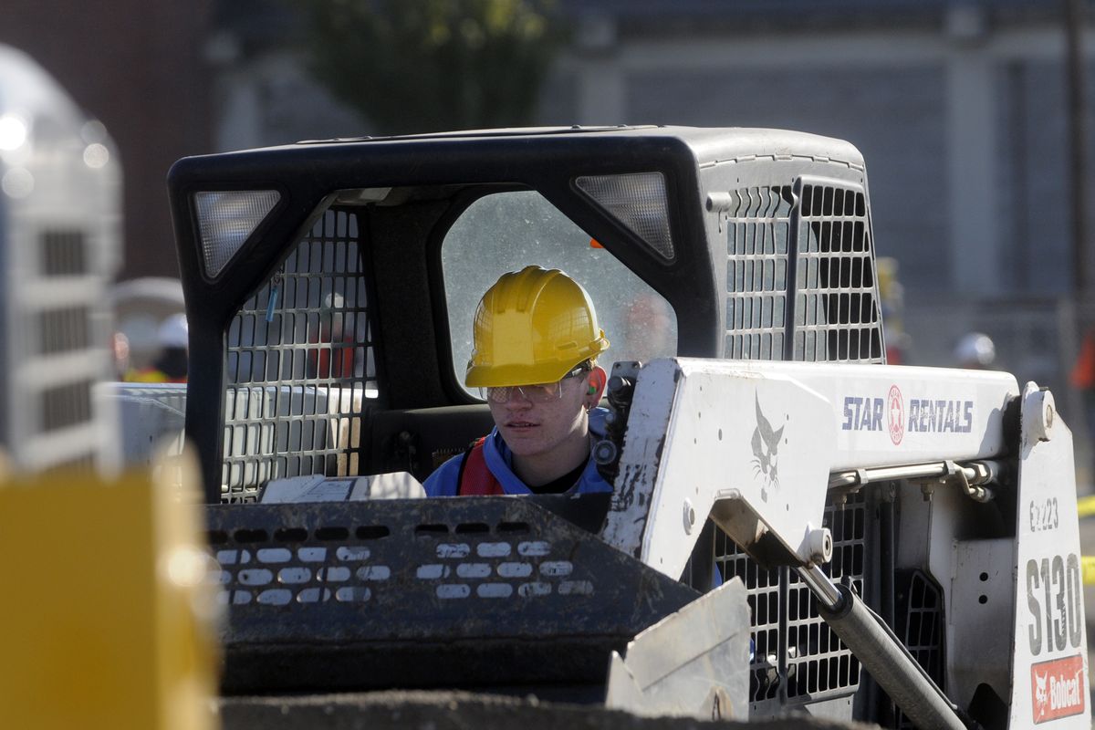 U-Hi senior Aaron Neely drives a Bobcat at the Spokane County Fair and Expo Center during Construction Career Day. (The Spokesman-Review)