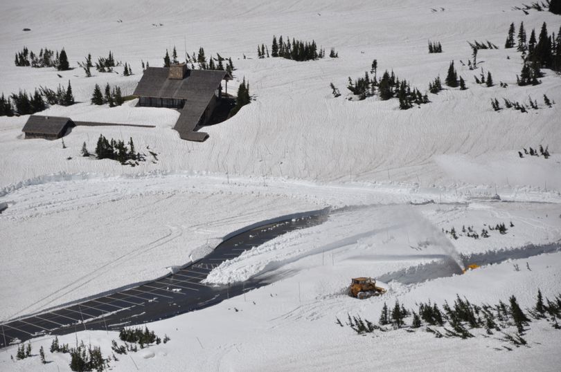 Glacier National Park road crews reach Logan Pass and begin clearing the visitor center parking area on June 4, 2013. (National Park Service)