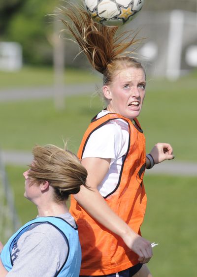 Whitney Ramsey gets a head on the ball during spirited competition at the Womens Premier Soccer League expansion Spokane Black Widows tryouts last Friday at Plantes Ferry Park. (Jesse Tinsley)