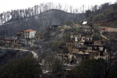 
Forest fires nearly destroyed the village of Livadaki, Greece,  seen on Monday. At least 63 people have died in the blazes. Associated Press
 (Associated Press / The Spokesman-Review)