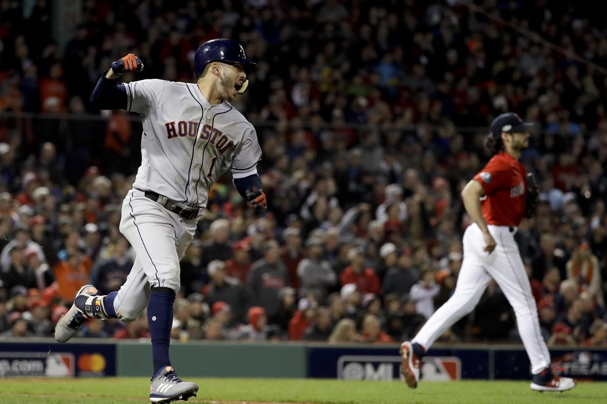 Houston Astros’ Carlos Correa celebrates after his RBI-single against the Boston Red Sox during the sixth inning in Game 1 of a baseball American League Championship Series on Saturday, Oct. 13, 2018, in Boston. (David J. Phillip / Associated Press)