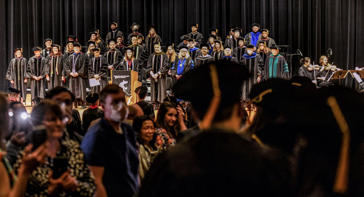 Graduates enter the Martin Woldson Theater during WSU College of Pharmacy and Pharmaceutical Commencement at the Fox in May 2022.  (Kathy Plonka/The Spokesman-Review)