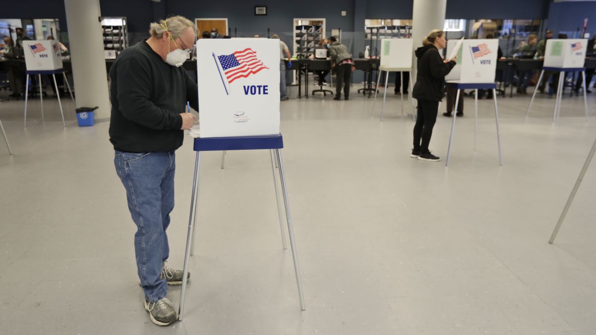 This Tuesday, April 28, 2020 file photo shows Jerome Fedor, left, voting using social distancing at the Cuyahoga County Board of Elections, in Cleveland, Ohio. Ohio