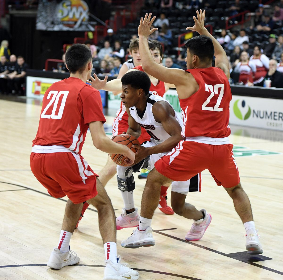 St. George’s guard Dan Rigsby dribbles the ball as is defended by Brewster forward Aj Woodward (20) and guard Adaih Najera (22) during a State 2B boys semifinal game on Friday, March 6, 2020, at the Spokane Arena. (Colin Mulvany / The Spokesman-Review)