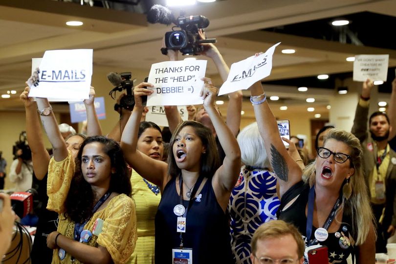 Protesters yell as DNC Chairwoman, Debbie Wasserman Schultz, D-Fla., arrives for a Florida delegation breakfast, Monday, in Philadelphia, during the first day of the Democratic National Convention. (AP Photo/Matt Slocum)
