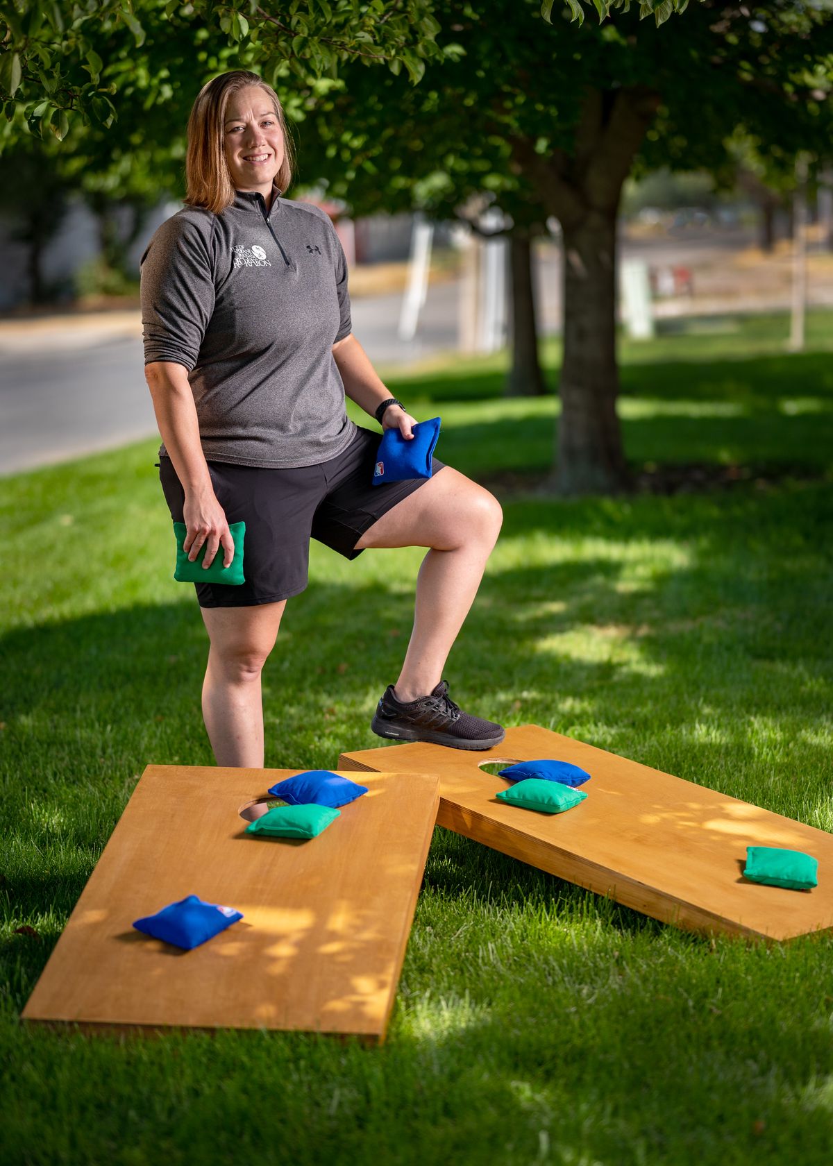 Carissa Ware, Adults Athletics & Field Allocations supervisor, stands by a new cornhole set on Tuesday. The Parks and Recreation department is establishing a cornhole league next month, among its first competitive offerings since the start of the pandemic.  (Colin Mulvany/The Spokesman-Review)