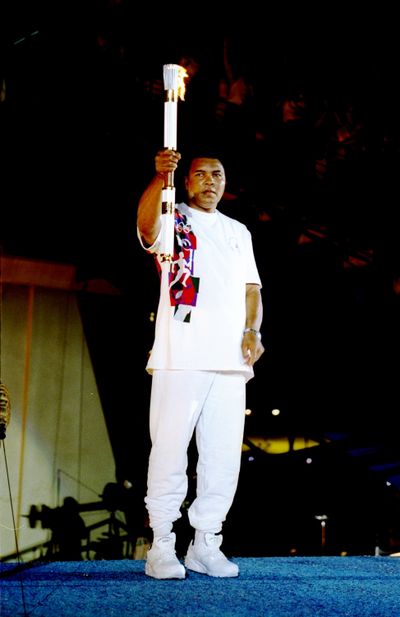 Muhammad Ali holds the torch before lighting the Olympic flame during the opening ceremony of the 1996 Summer Olympic on July 19, 1996, in Atlanta.  (Michael Cooper/Allsport/Getty Images North America/TNS)