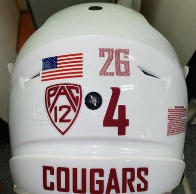 The helmet of Washington State quarterback Jayden de Laura is pictured. Cougar players are wearing stickers with Bryce Beekman's No. 26 this season.  (Washington State Equipment)