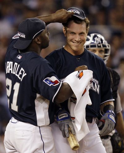 Texas Rangers’ Milton Bradley, left, wipes down teammate Josh Hamilton during  the Home Run Derby at Yankee Stadium.  (Associated Press / The Spokesman-Review)