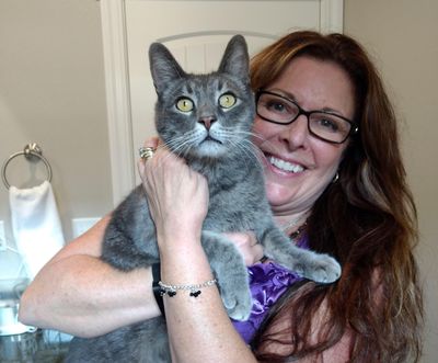 In this Oct. 3, 2018, photo, Susan Cortopassi holds her cat, Big Ernie after the pair were reunited after they were separated in the Carr Fire in Redding, Calif. Cortopassi thought Big Ernie was killed in the fire but like many other pets feared dead, Big Ernie survived. (Linda Larson / Courtesy of Linda Larson)