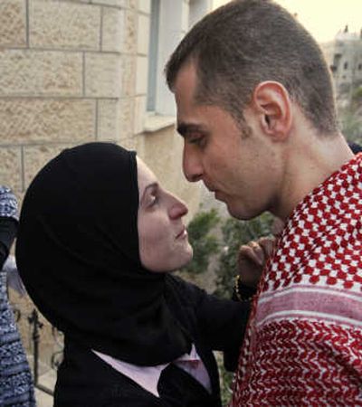 
Palestinian Fadi Abu Salah, 28, freed from an Israeli jail, reunites with his wife in the West Bank village of Arabeh on Monday. Associated Press
 (Associated Press / The Spokesman-Review)