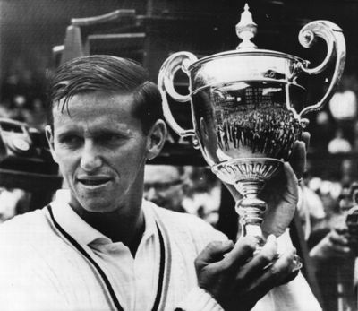 Roy Emerson, showing off the Wimbledon championship trophy he won in 1965, captured 12 Grand Slam individual titles and 16 Grand Slam doubles titles – a record for men.  (File Associated Press / The Spokesman-Review)