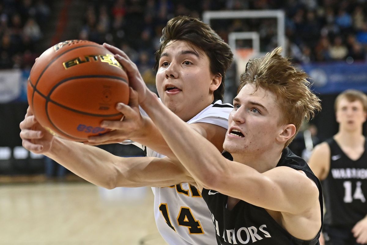 Cusick Panthers forward Kyden Nomee (14) rebounds the ball against Almira-Coulee-Hartline Warriors guard Grady Murray (25) in the first half of the State 1B Boys Championship basketball game at the Spokane Arena on Sat, March. 5, 2022 in Spokane WA.  (James Snook For The Spokesman-Review)