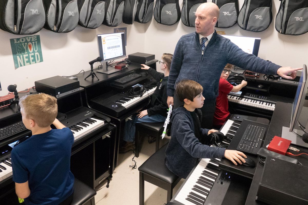 Spencer Normington shows the kids how to shut down their music workstations at Ramsey Magnet School of Science in Coeur d’Alene on Wednesday. (Jesse Tinsley / The Spokesman-Review)