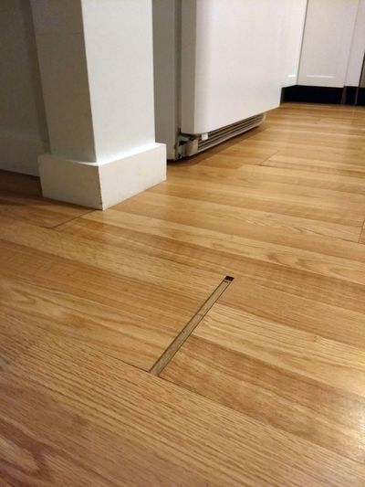 The gaps in this laminate floor come and go. The installer failed to read and follow the installation instructions. (Tim Carter)