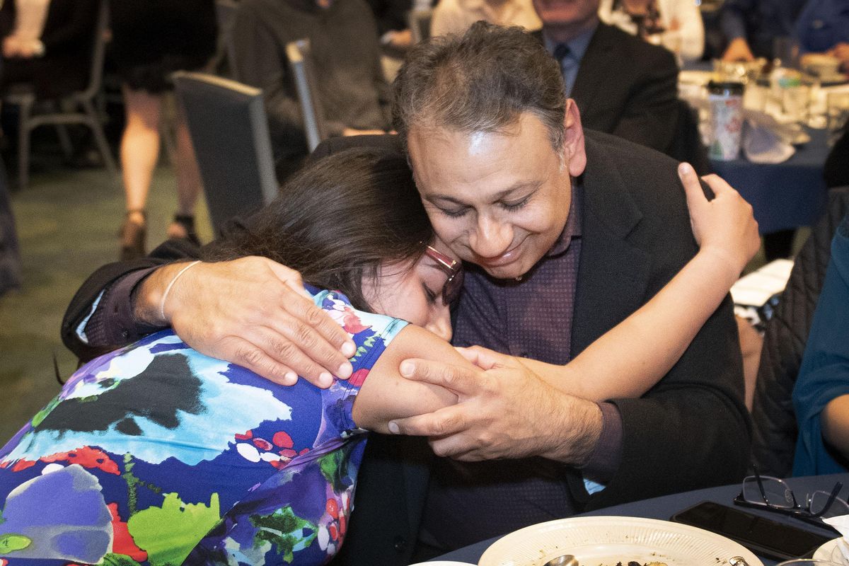 After receiving the $4,000 Spokane Scholars Foundation Award for English, Ilina Logani from Gonzaga Prep receives a proud hug from her father, Sanjay, on Monday night. (Colin Mulvany / The Spokesman-Review)