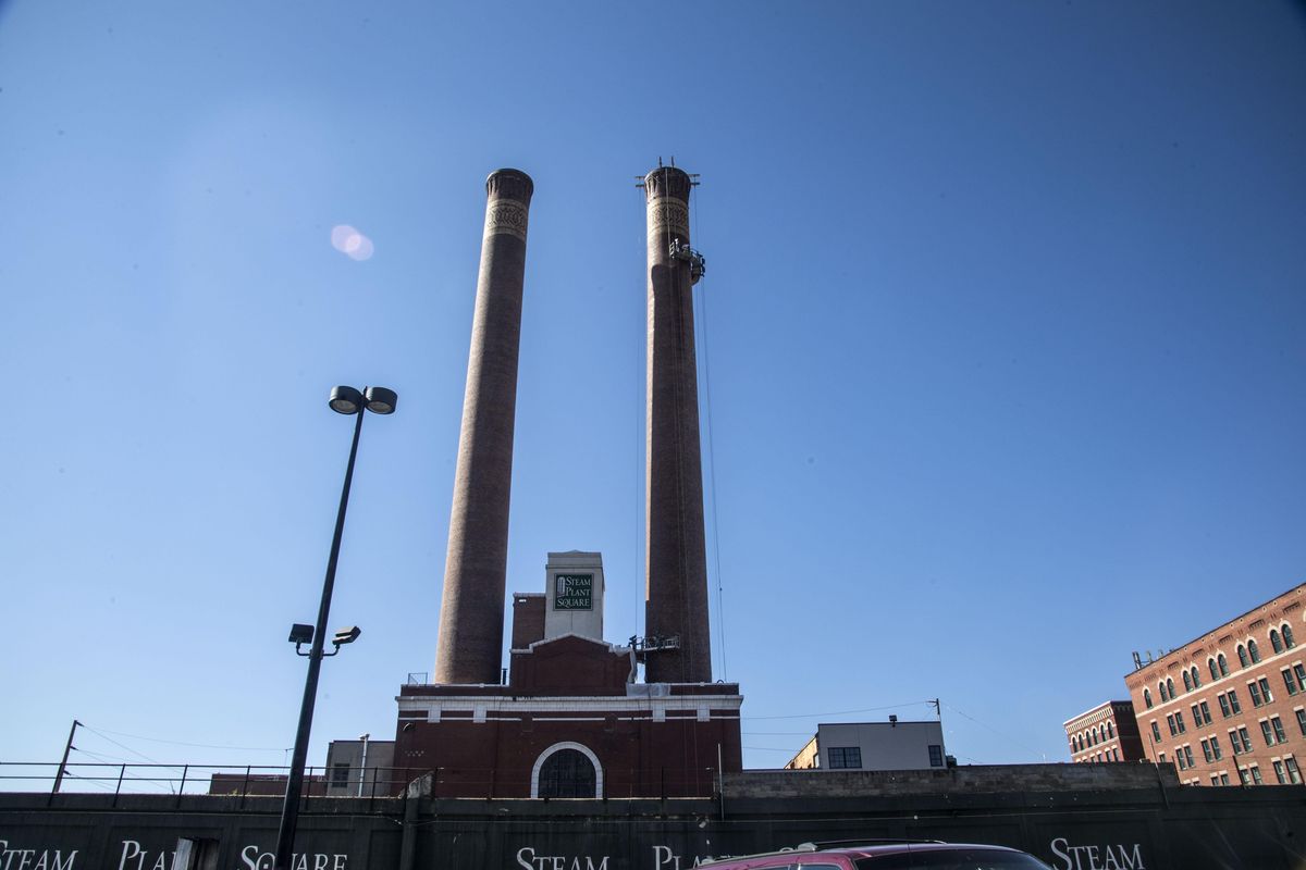 Crews from Hamon Custodis work on the west stack at Steam Plant Square, July 13, 2017. (Dan Pelle / The Spokesman-Review)