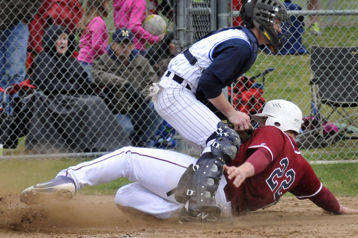 Mead’s Jordan McGowan, tagging out Mt. Spokane’s Tanner Conroy, is learning to play catcher for the first time since sixth grade. (Jesse Tinsley)