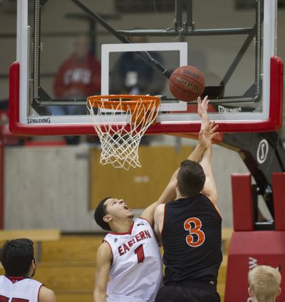 Eastern Washington’s Tyler Harvey, left, tries to disrupt shot of Idaho State’s Ben Wilson on Saturday in Cheney. (Tyler Tjomsland)