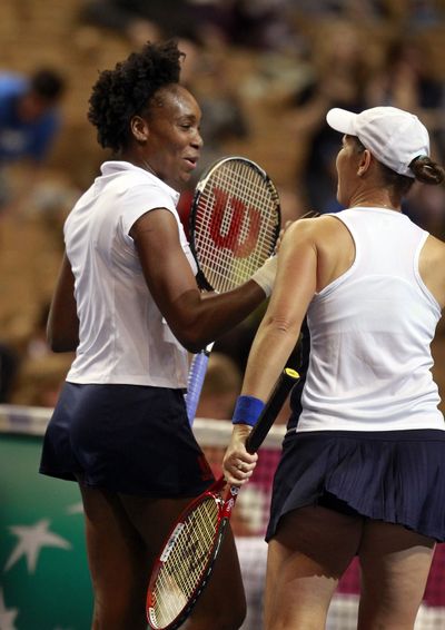 Venus Williams, left, and Liezel Huber celebrate doubles win. (Associated Press)