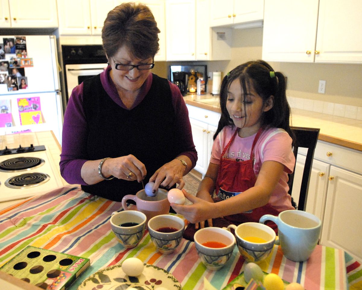 Mentor Sherry Barrett colors Easter eggs with 9-year-old Eloisa Garcia, something Eloisa had never done before.  (J. BART RAYNIAK / The Spokesman-Review)