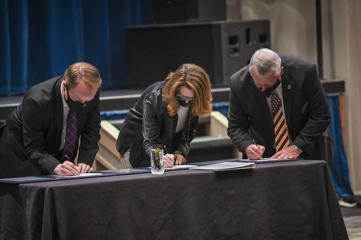 Spokane County Commissioners Josh Kerns, Mary Kuney and Al French sign an historic Air Force-Spokane County agreement for a Spokane Regional Indoor Small Arms Range Partnership during a ceremony Monday, March 15, 2021, at Northern Quest Casino.  (COLIN MULVANY/THE SPOKESMAN-REVIEW)