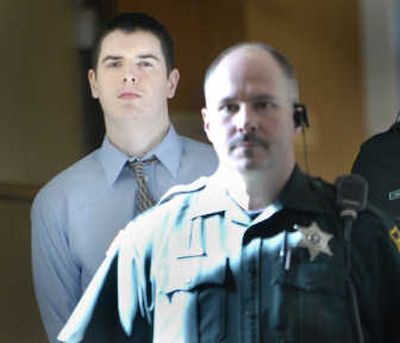 
Travis R. Ault, left, is led into Judge Maryann Moreno's courtroom Tuesday, where he pleaded guilty to two counts of murder. 
 (Holly Pickett / The Spokesman-Review)