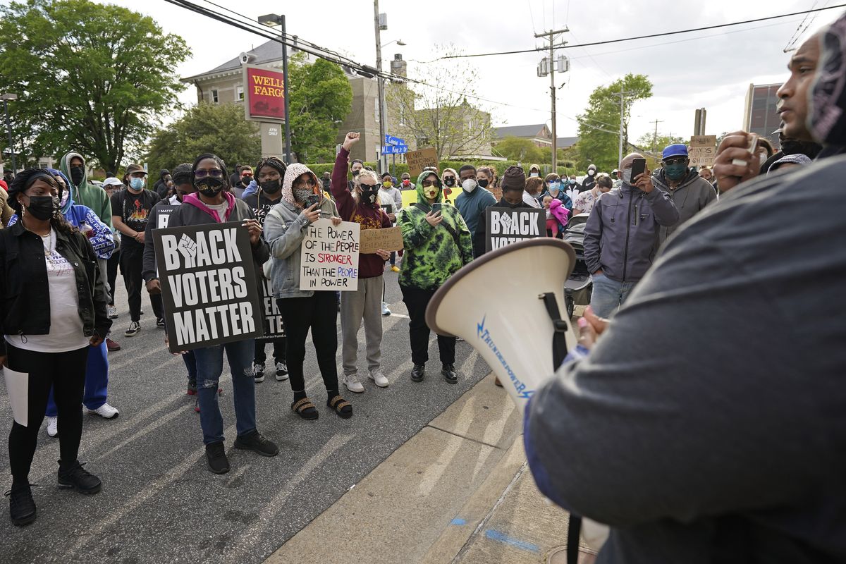 People gather for a peaceful demonstration, Thursday, April 22, 2021, in Elizabeth City, N.C., protesting the shooting of Andrew Brown Jr., 42, by a deputy sheriff trying to serve a search warrant.  (Gerry Broome)