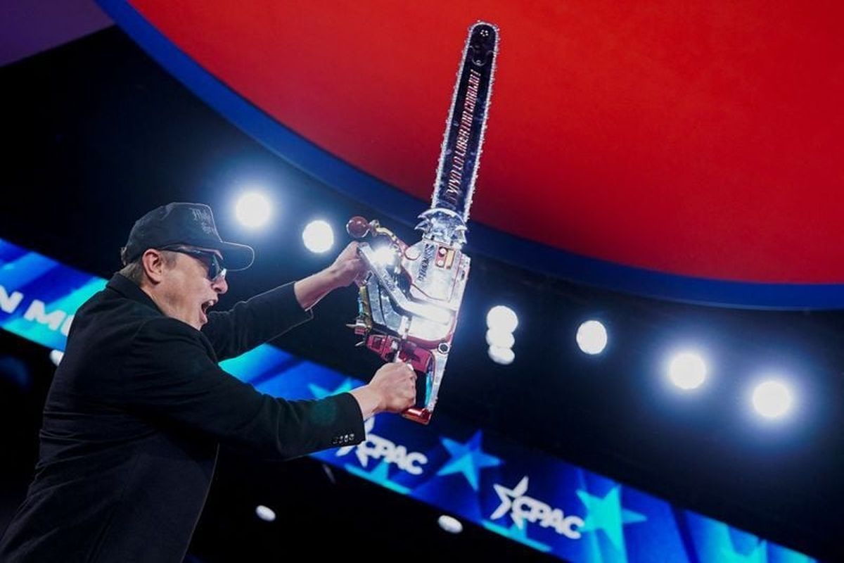 Elon Musk holds up a chainsaw onstage during the Conservative Political Action Conference (CPAC) in National Harbor, Maryland, U.S., February 20, 2025.   (Nathan Howard/Reuters)