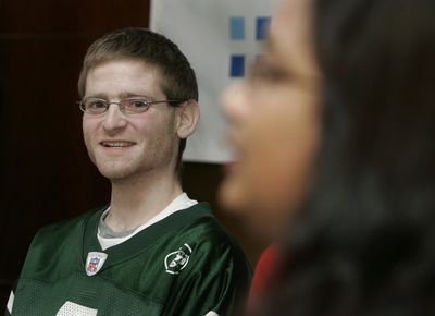 Double-lung transplant patient John Muscarella, 21, smiles, while wearing a New York Jets jersey Wednesday at Newark, N.J.’s Beth Israel Medical Center.   (Associated Press / The Spokesman-Review)