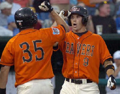 
John Wallace, left, welcomes OSU's Cole Gillespie after his two-run homer. 
 (Associated Press / The Spokesman-Review)