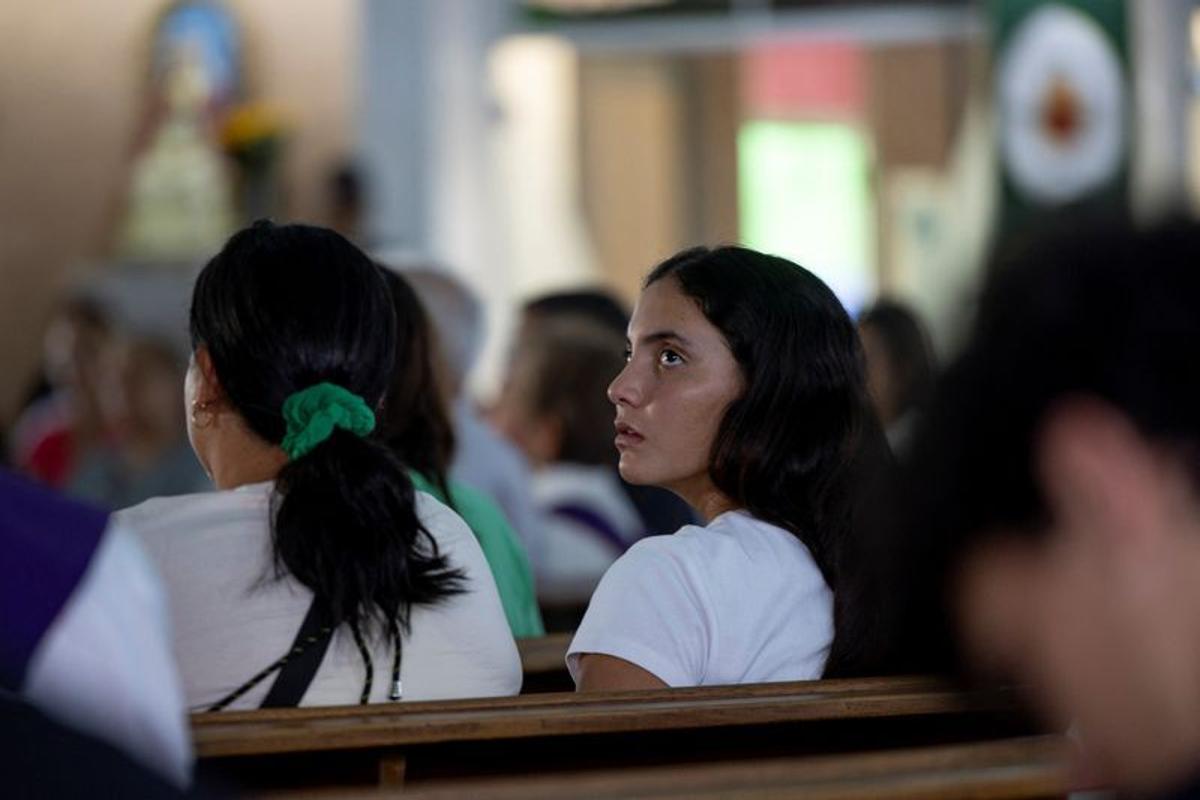 Maria Alejandra Sanz, who survived after spending 17 hours trapped beneath the rubble of her collapsed apartment building following twin earthquakes in La Guaira, attends a memorial service for one of her friends at Iglesia Maria Auxiliadora in Caracas, Venezuela, July 7, 2026. REUTERS/Ricardo Arduengo  (Ricardo Arduengo)