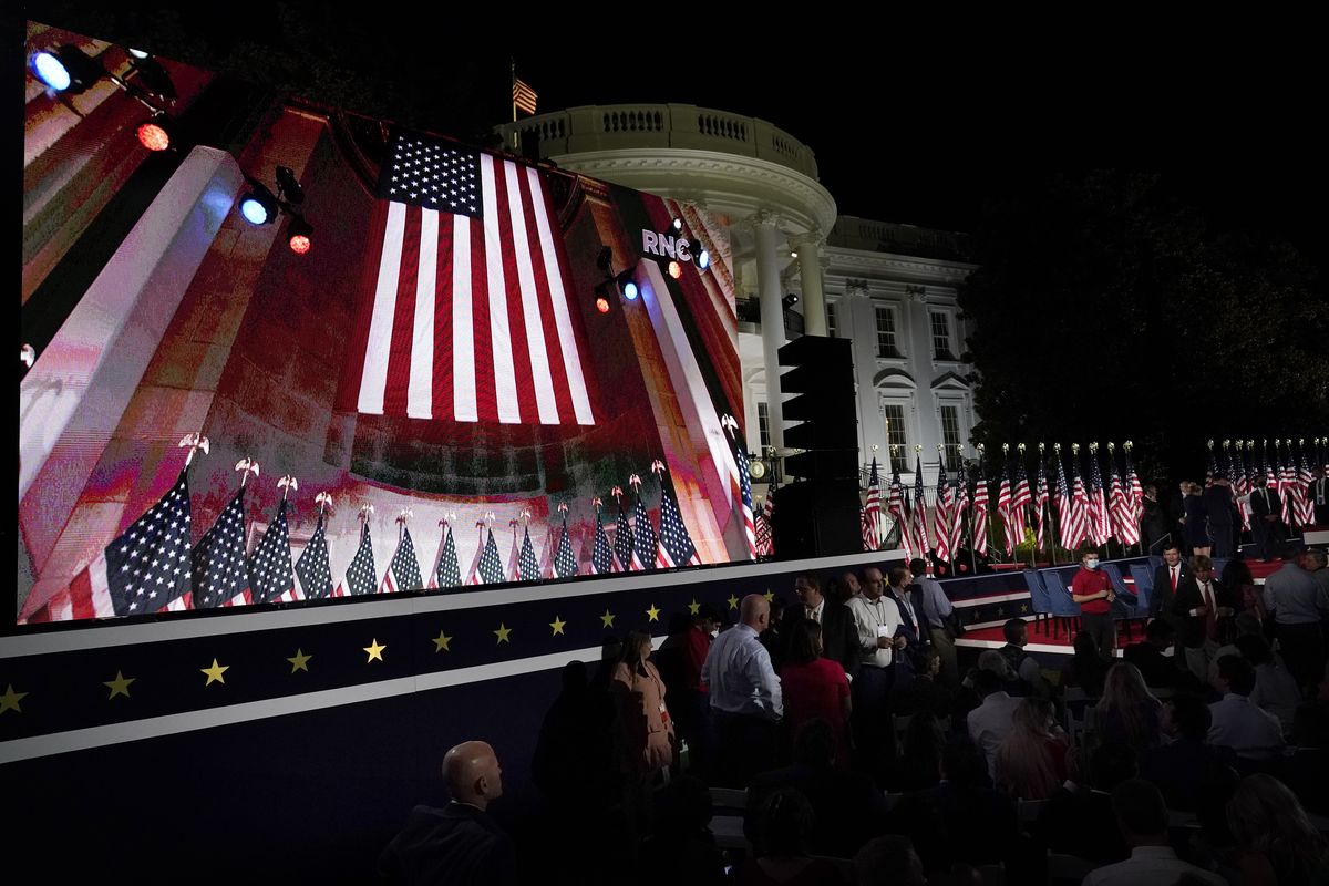 The Republican National Convention video is displayed on a screen as people watch from the South Lawn of the White House on the fourth day of the convention Thursday, Aug. 27, 2020, in Washington. (Alex Brandon)
