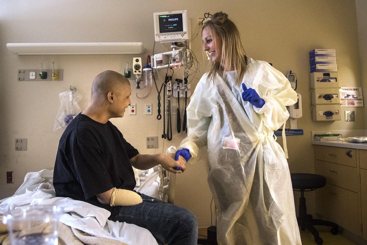 Alyssa Vanderzee, education specialist for the Andrew Rypien School Program, shakes hands with Leo Valdez, 17, from Tonasket, Wash., Wednesday at Sacred Heart Children’s Hospital. Vanderzee was helping Valdez set up his enrollment for his GED. (Dan Pelle / The Spokesman-Review)