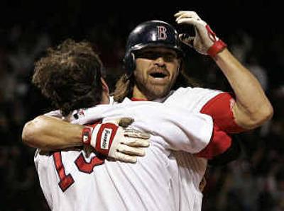 
Boston Red Sox's Johnny Damon is congratulated at the plate by teammate Doug Mientkiewicz after scoring the game-winning run against the New York Yankees in game 5 of the ALCS Monday. 
 (Associated Press / The Spokesman-Review)