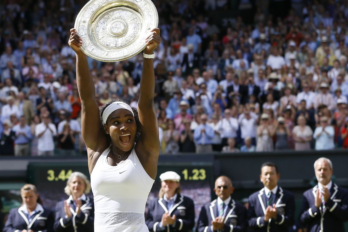 Serena Williams holds up the champion’s trophy – and would also balance it on her head – after winning the women’s singles final against Spain’s Garbine Muguruza. (Associated Press)