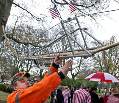 Longview Parks employee Kurt Nedved helps raise the Nutty Narrows Bridge to its new home on Olympia Way in Longview, Wash., on November 2010. The squirrel crossing has been added to the National Register of Historic Places. (Associated Press)
