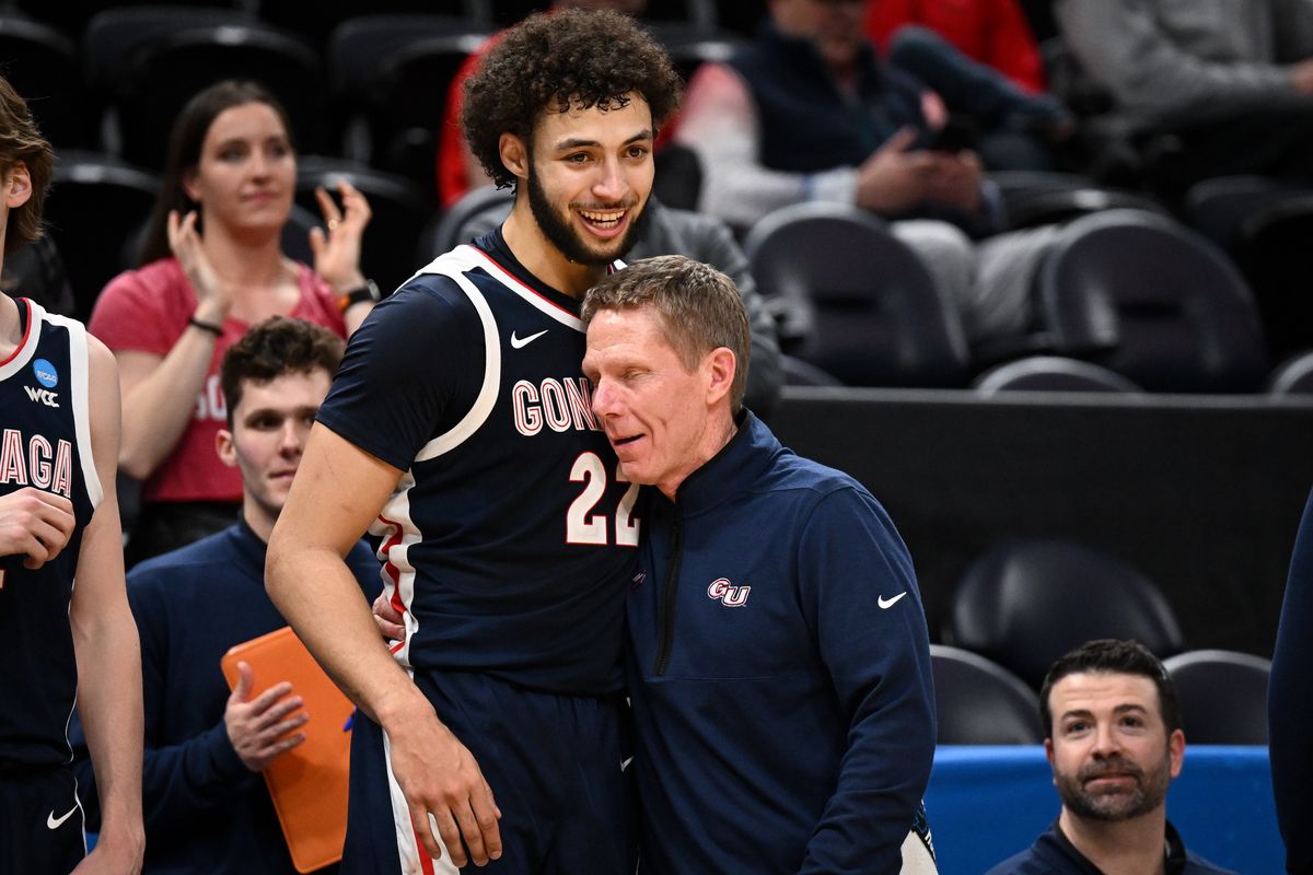 Gonzaga Bulldogs head coach Mark Few embraces forward Anton Watson (22) who had 21 points against the Kansas Jayhawks, after Watson came out of the game late during the second half of an NCAA basketball tournament second round game on Saturday, Mar 23, 2024, at the Delta Center in Salt Lake City, Utah. Gonzaga won the game 89-68.  (Tyler Tjomsland/The Spokesman-Review)
