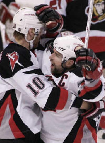 Buffalo's Henrik Tallinder, left, celebrates his first-period goal with teammate Chris Drury.
 (Associated Press / The Spokesman-Review)
