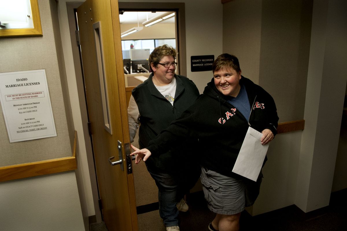 Kim Malar, left, and Jennifer Currie, both of Post Falls and Kootenai County natives, emerge Wednesday as the first same-sex couple in the county to obtain a marriage license. They visited the courthouse during their lunch break. “We have our life here,” Malar said. (Kathy Plonka)