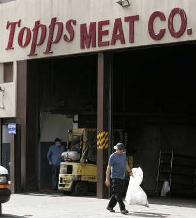 A man carries a garbage bag from the Topps Meat Co. plant in Elizabeth, N.J., this week. As government scientists searched for the source of a multistate E. coli outbreak linked to Topps frozen hamburgers, a class-action lawsuit was filed Wednesday against the producer of the patties and supermarkets that sold them.Associated Press
(Associated Press / The Spokesman-Review)