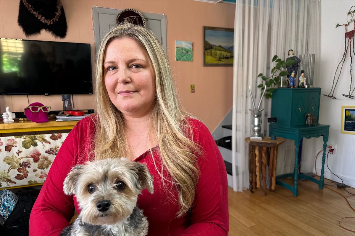 Kyra Wiedenkeller, of New York, with her dog, Frankie. She has spent at least $100,000 out-of-pocket on TMJ treatment, but says she remains in “unrelenting pain.” TMJ disorders are not well covered by medical or dental insurance, leaving many patients to pay hundreds to tens of thousands of dollars out-of-pocket.  (KFF Health News)