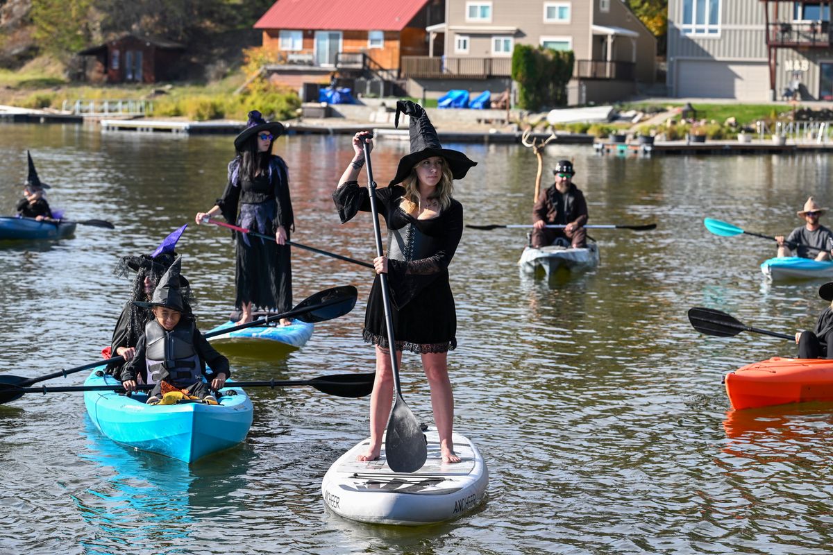 Paddlers on paddleboards and kayaks take a slow tour of Newman Lake on Saturday at the Witches and Warlocks Ride.  (Jesse Tinsley/THE SPOKESMAN-REVIEW)