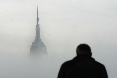 
Tom Seitz, of Cleveland, Ohio, looks at the fog-shrouded Empire State Building in New York City on Jan. 13, 2006. Built during the Great Depression, the towering edifice will turn 75 years old Monday. 
 (Associated Press / The Spokesman-Review)