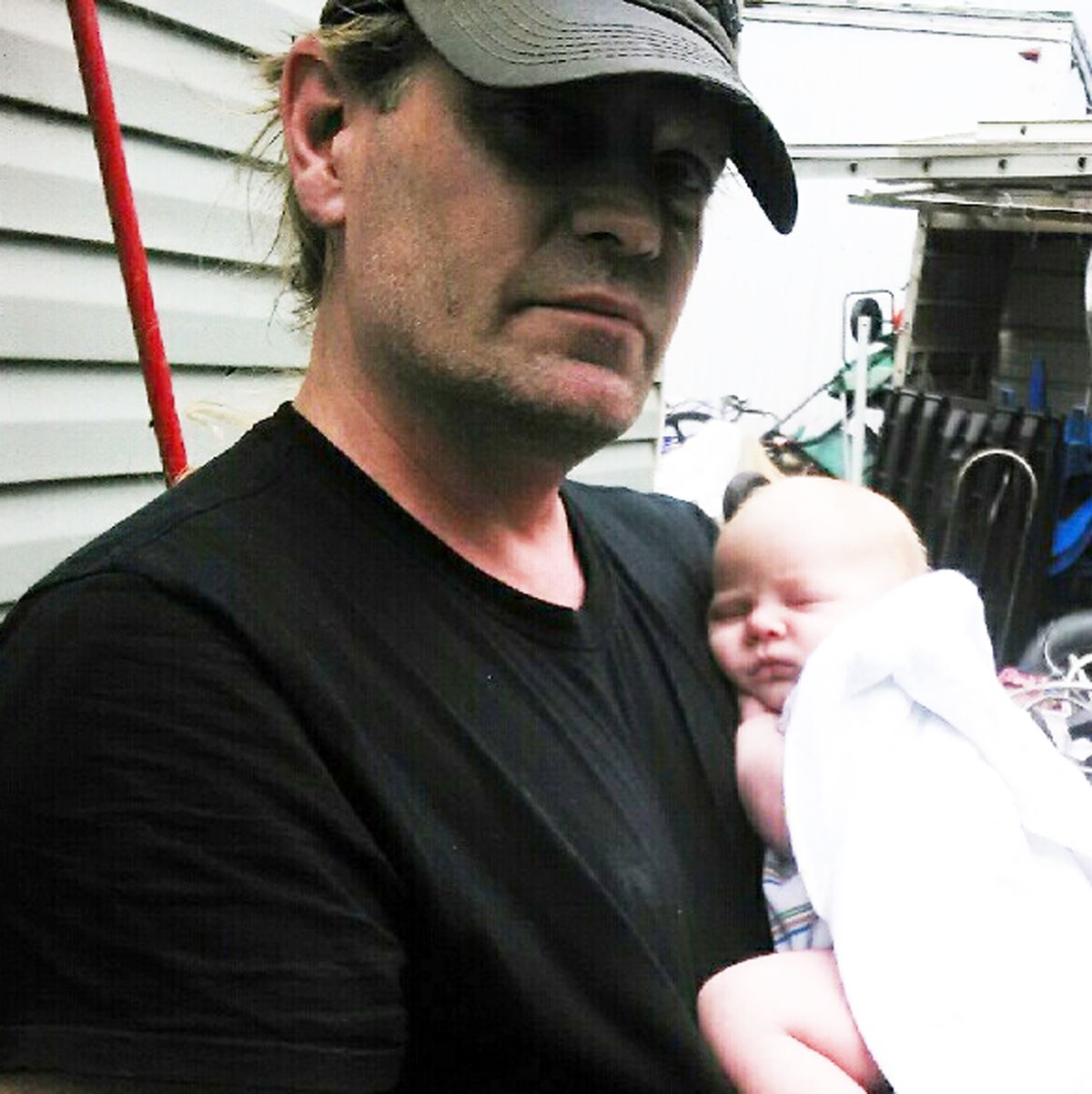 Robert Royer and his new baby are seen in this family photo. Royer was killed by a car Tuesday while biking in Spokane Valley. (Family)