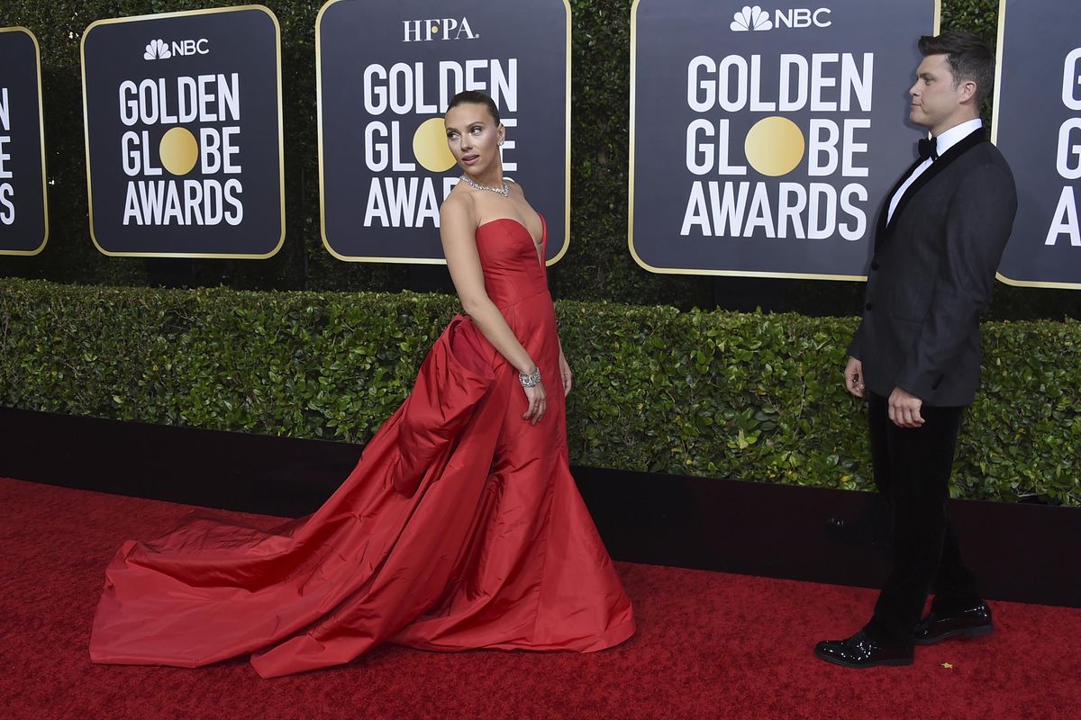 Scarlett Johansson, left, arrives as Colin Jost looks on at the 77th annual Golden Globe Awards at the Beverly Hilton Hotel on Sunday, Jan. 5, 2020, in Beverly Hills, Calif. (Jordan Strauss / Invision/Associated Press)