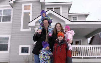 
Shane and Allison Young join their children Elexa, 3, top left, Ella, 6 months, right, Emilia, 5, bottom left, and Elliot, 8. The Youngs moved from Portland to their Coeur d'Alene home to be closer to family.
 (Kathy Plonka / The Spokesman-Review)