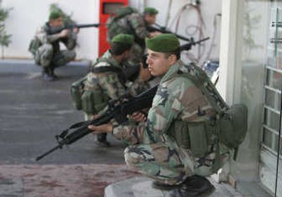 
Lebanese soldiers take positions Sunday in Beirut's Shiite southern suburb of Shiyah. Associated Press
 (Associated Press / The Spokesman-Review)