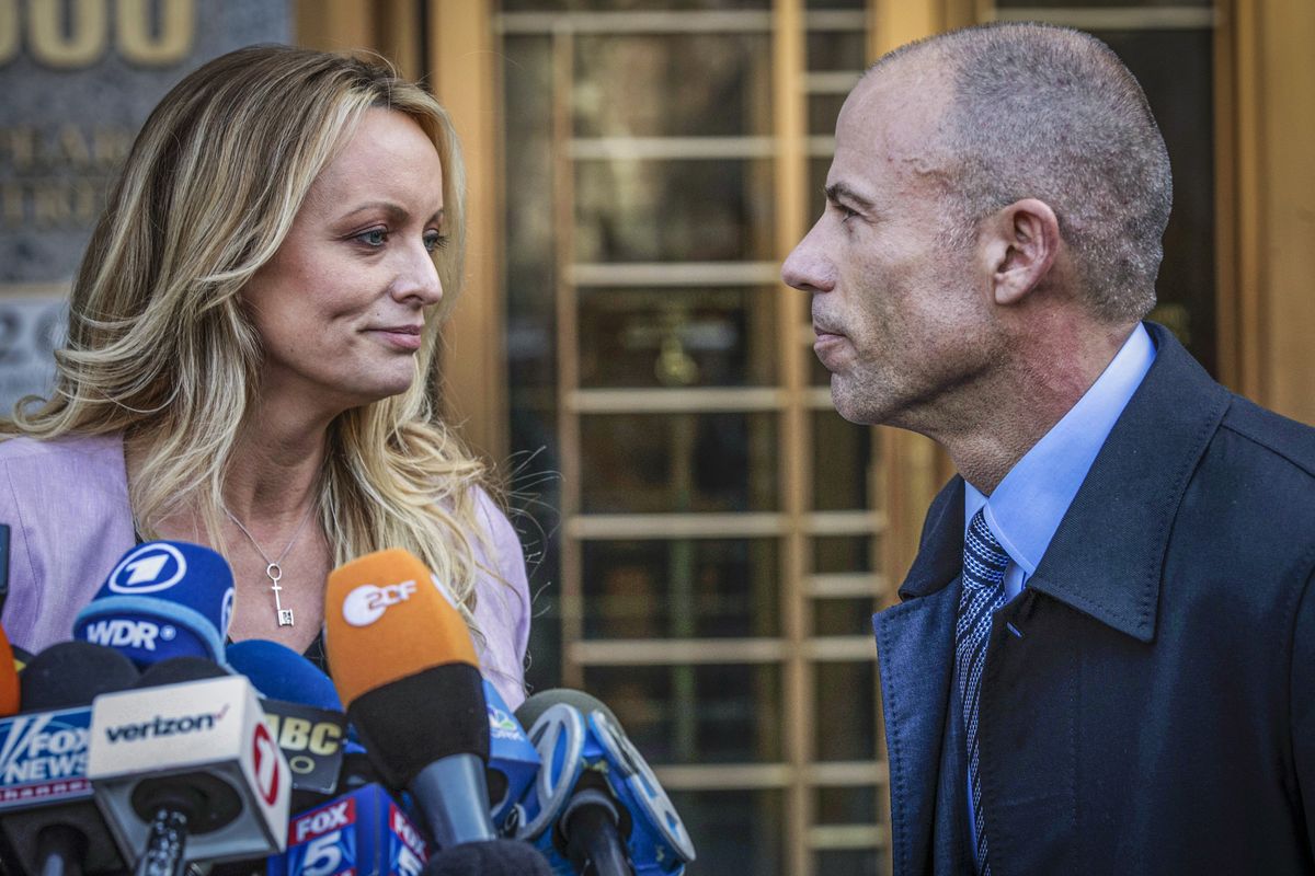 FILE - Adult film actress Stormy Daniels, left, stands with her lawyer Michael Avenatti during a news conference outside federal court in New York, April 16, 2018. Daniels, the porn star who catapulted Avenatti to fame, will get a starring role in a New York courtroom when prosecutors try to prove the California lawyer cheated her of $300,000 in book proceeds.  (Mary Altaffer)